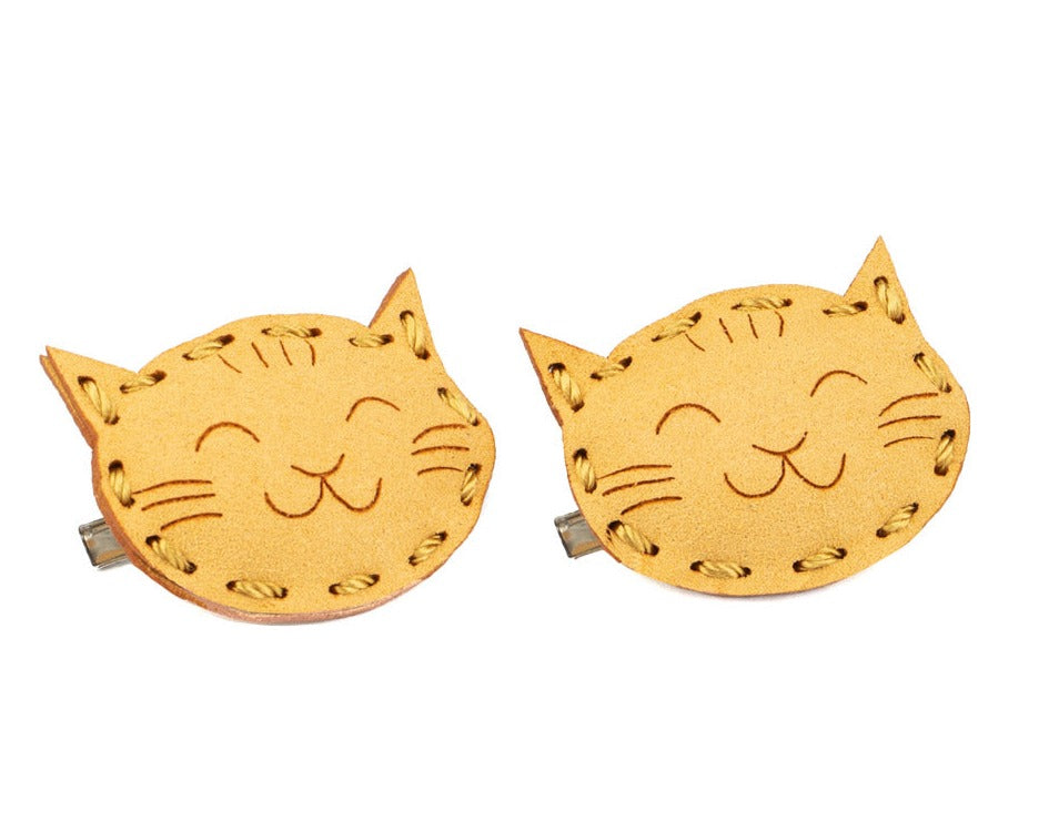 A cute pair of smiling cat faces. yellow color